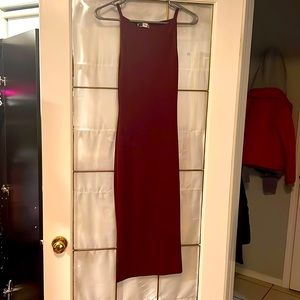 Long burgundy sleeveless dress.